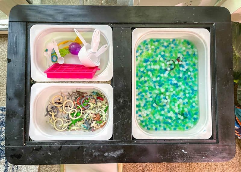 Amphibian and Reptile sensory bin activity. Green, blue, and white water beads in one bin. Snakes, frogs and alligators in another bin. Sensory bin toys in another.