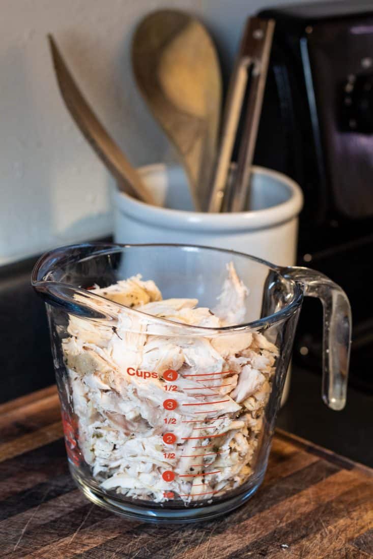 4 cups shredded chicken in a large glass measuring cup.