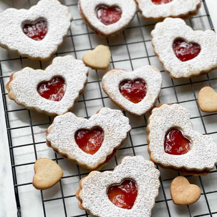 Heart-shaped Strawberry Jam cookies on a cooling rack