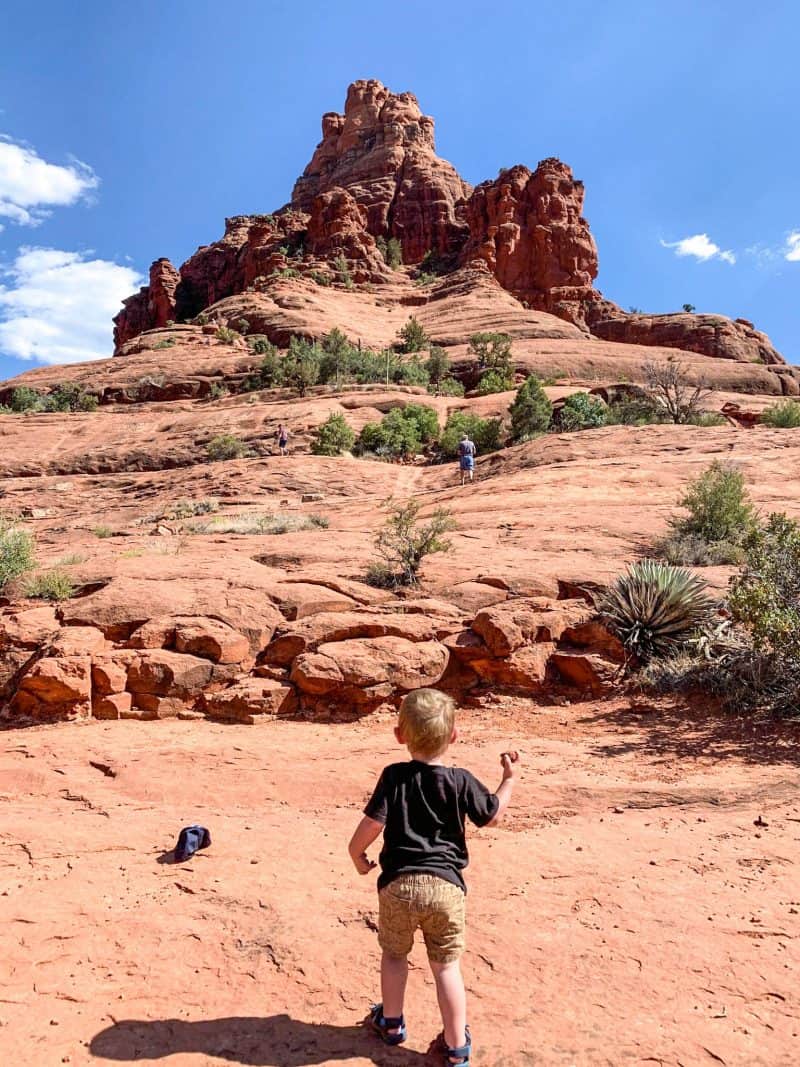 baby standing facing Sedona Rocks